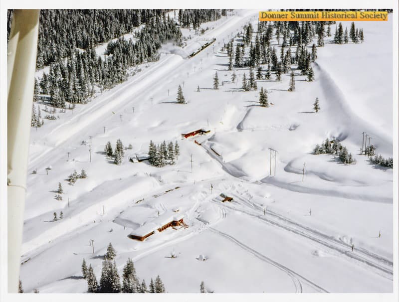 Aerial photograph of a snow-covered Soda Springs ski resort and the surrounding Donner Summit terrain.